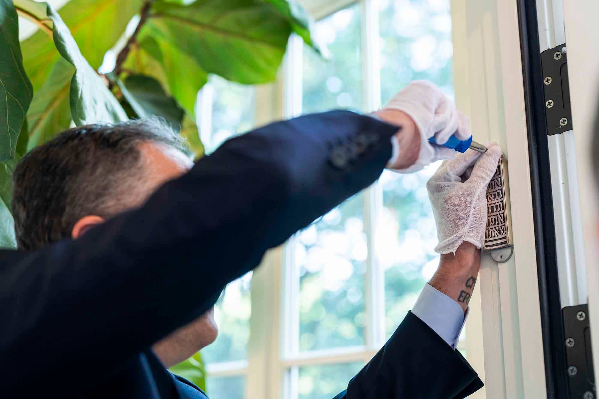 Second Gentleman Douglas Emhoff installing mezuzah