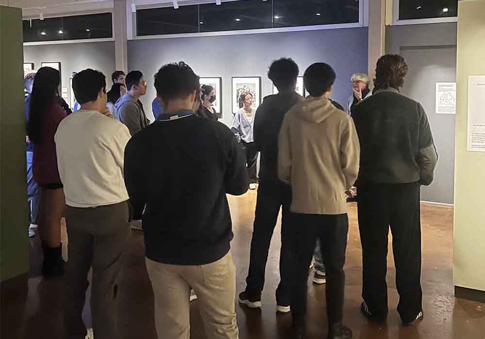curator speaking with group of students in gallery