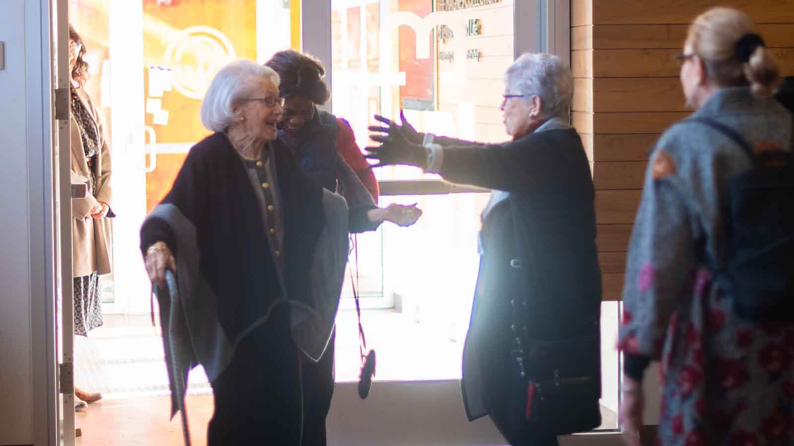 Women greeting each out at the entrance of the museum
