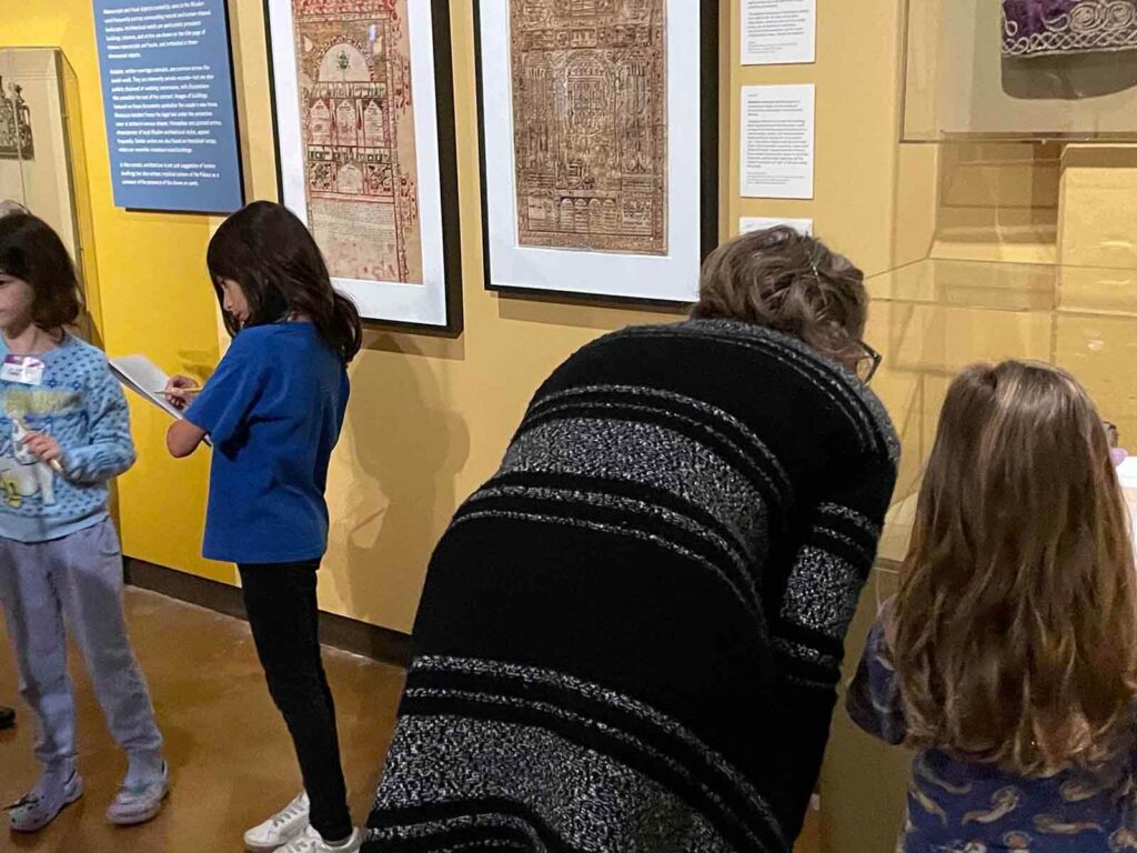 children and educator in gallery