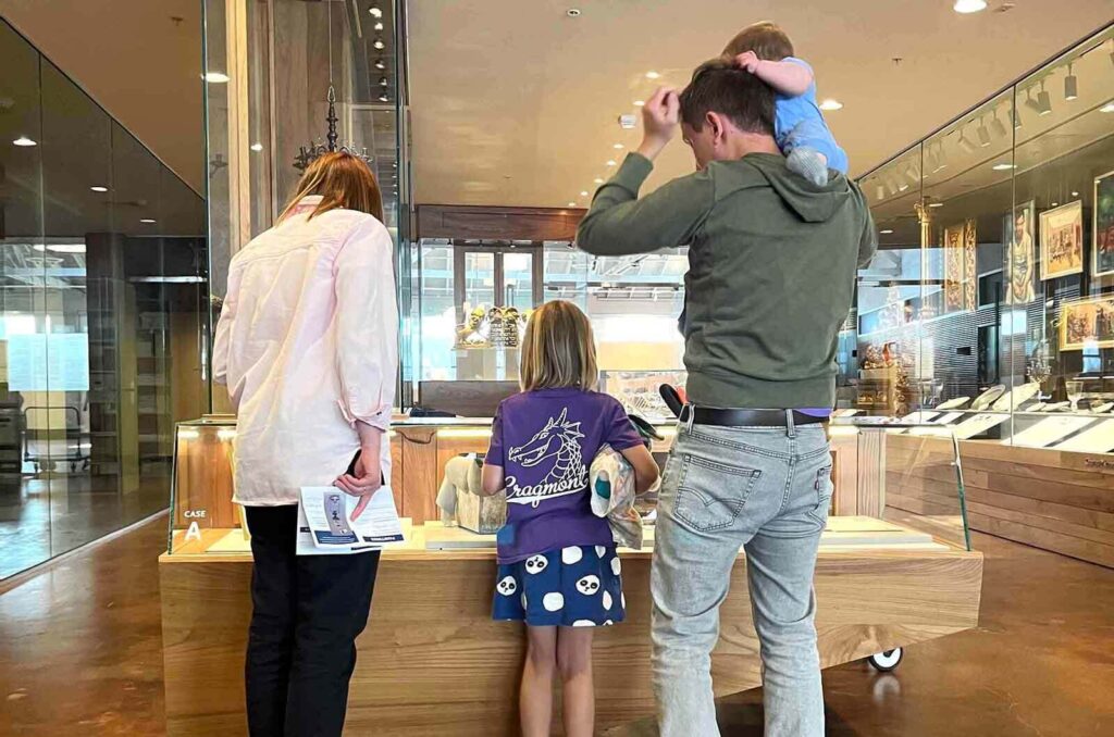 Young family looking at display case in exhibition