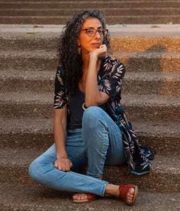 woman with long hair sitting on stairs