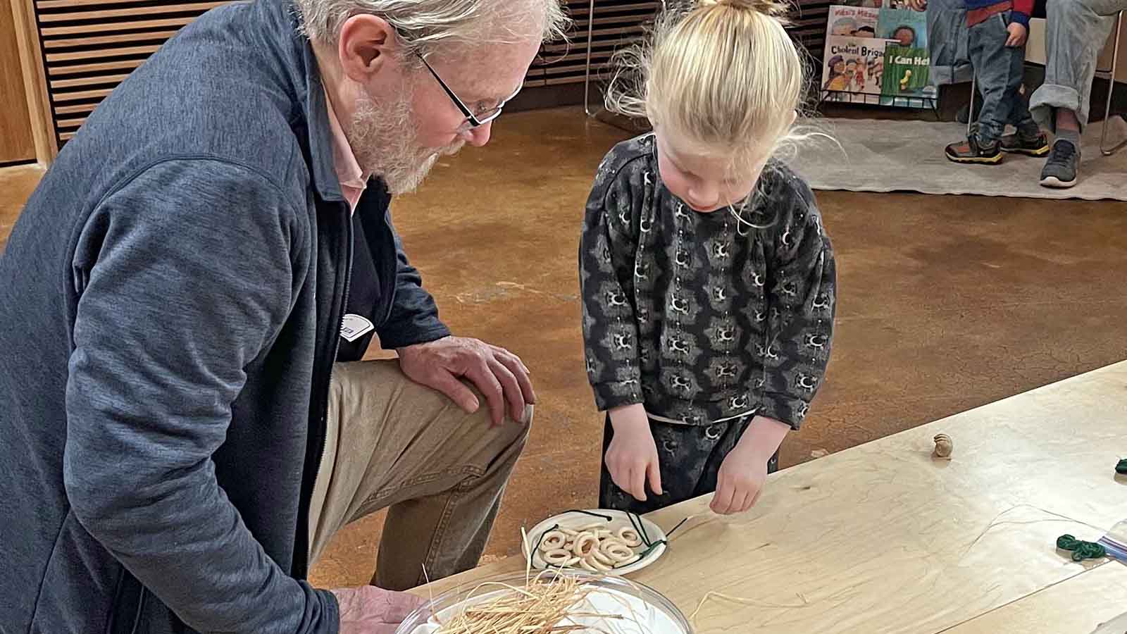 grandfather and preschooler working on a craft together