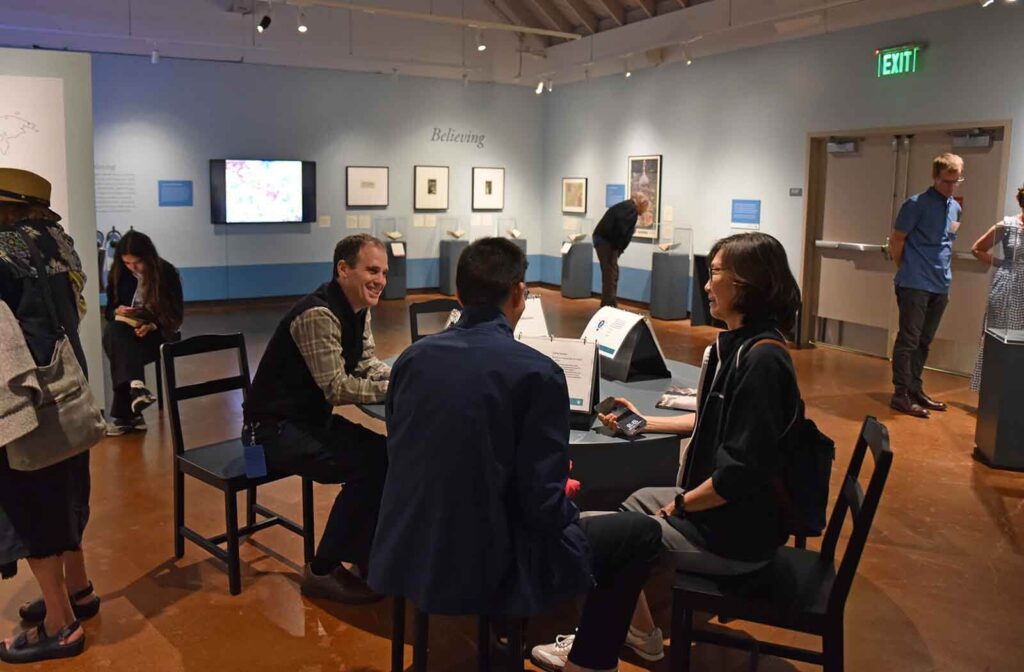 People sitting at table in exhibition
