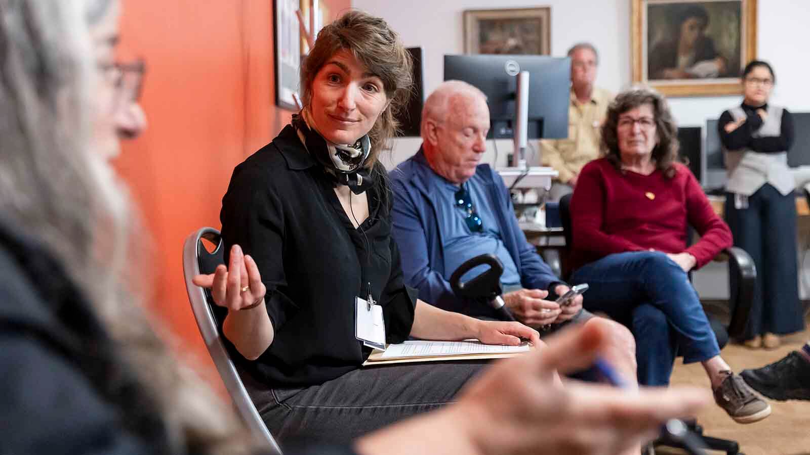Woman in discussion with small group